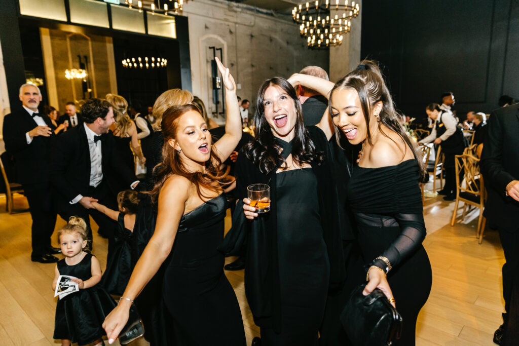 wedding guests dancing at black attire Cescaphe wedding reception by Emily Wren Photography