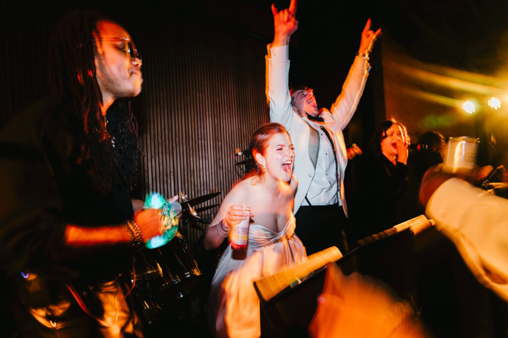 bride and groom dancing on stage at their Switch House by Cescaphe wedding reception