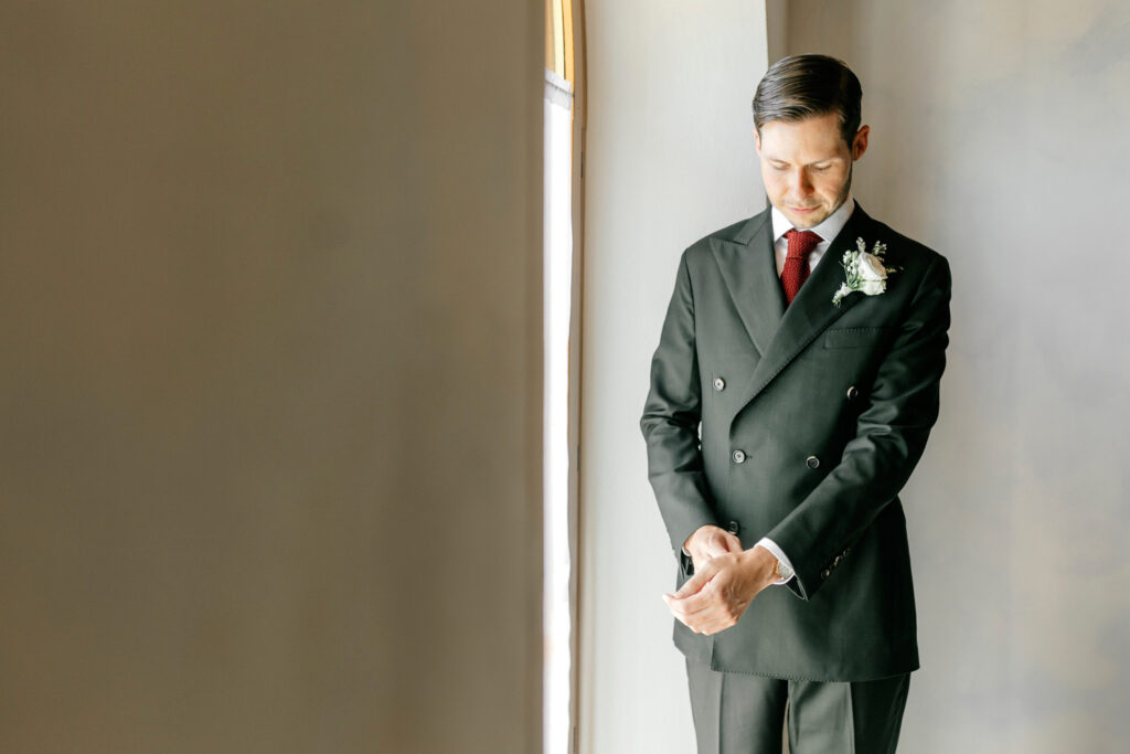 groom in green tinted tux