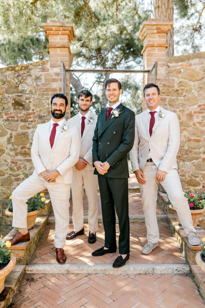 groom with groomsmen in cream groomsmen suits