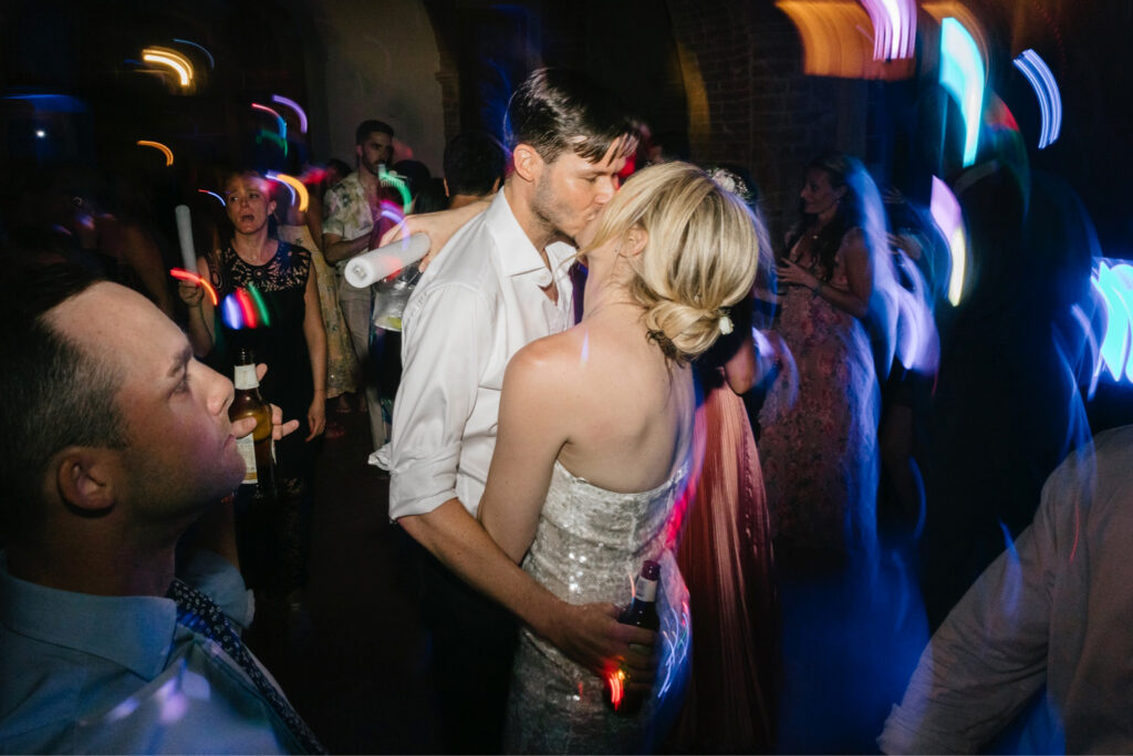 bride & groom kissing at their Italian wedding reception at Borgo Sant'Ambrogio by Emily Wren Photography