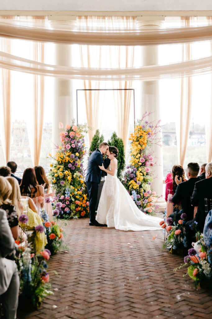 bride & groom's first kiss at their spring Cescaphe wedding ceremony at Water Works