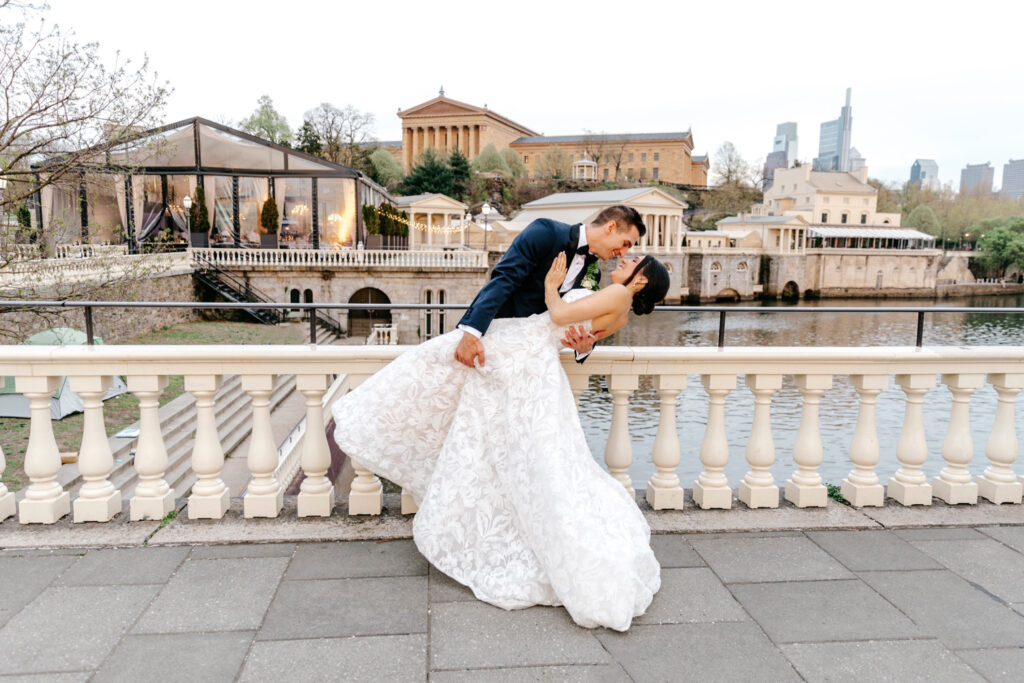 portrait of Philadelphia bride and groom at Water Works, with the Art Museum in the background