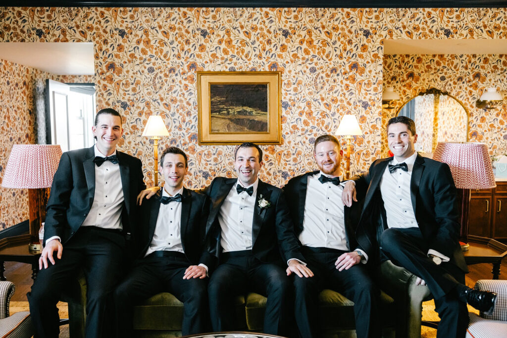groom with his groomsmen in his childhood home on the morning of his New Jersey wedding day