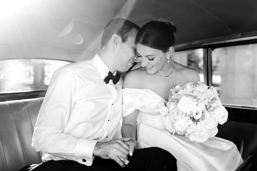 portrait of bride & groom in vintage Rolls Royce by Emily Wren Photography