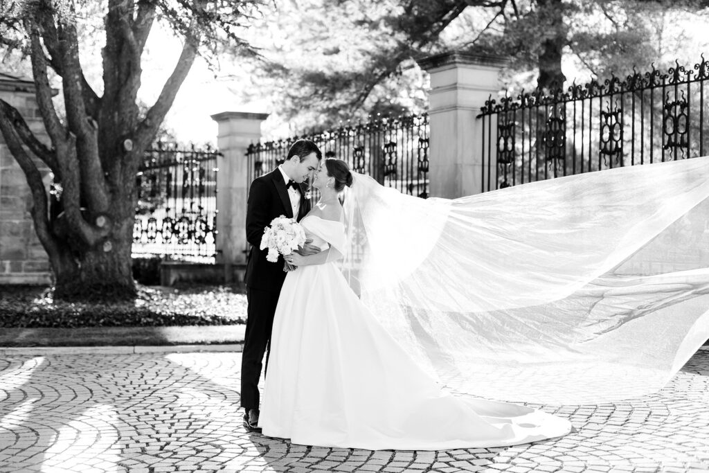 bride & groom portrait session at Jasna Polana as the bride's veil blows in the wind by Emily Wren Photography