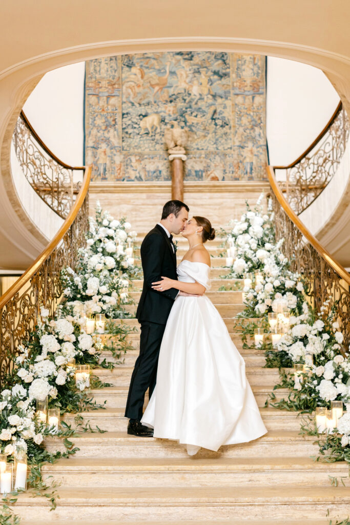 bride & groom kissing on the Jasna Polana staircase by Emily Wren Photography