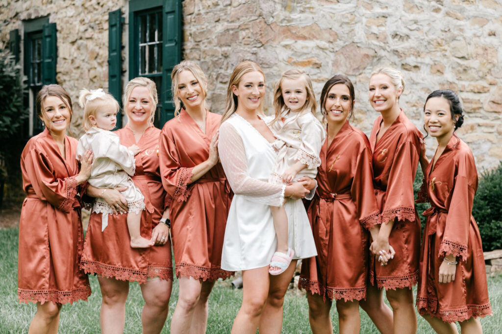 Pennsylvania bride on the morning of her New Hope wedding day with her bridesmaids in satin copper robes