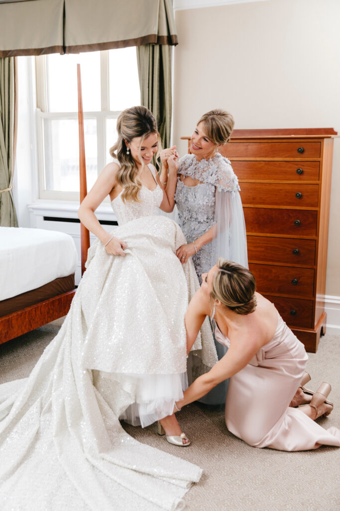 Luxury bride getting ready for her spring Philadelphia wedding day with her mother & bridesmaid
