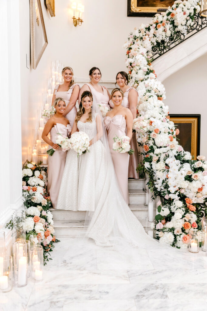 Spring Philadelphia bride with her bridesmaids in pink bridesmaid dresses at The Union League