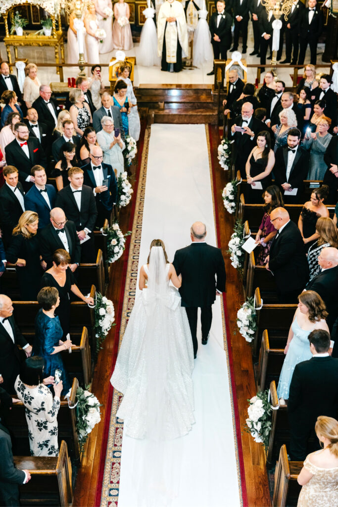 Philadelphia bride walking down the aisle at her Greek Orthodox wedding at St George's Cathedral