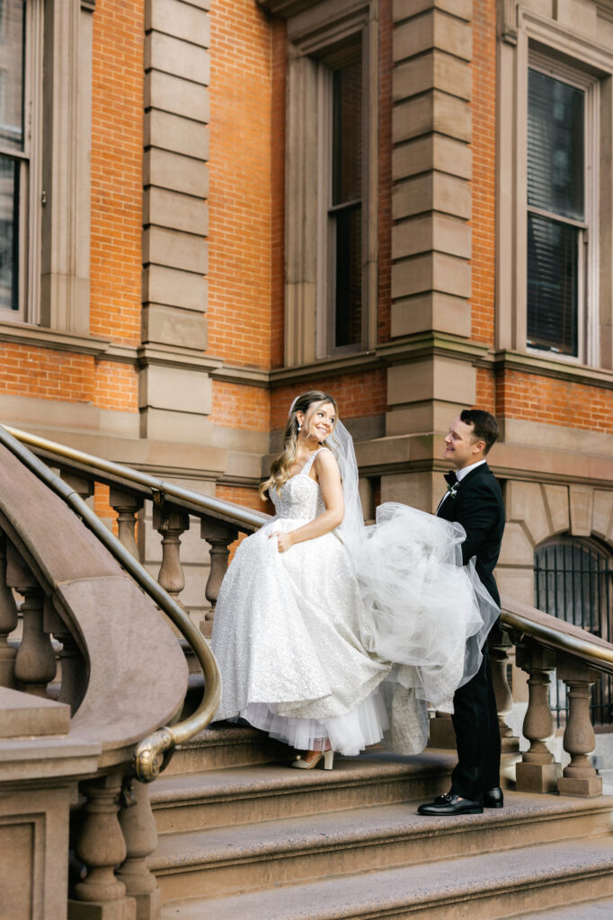 Philadelphia bride & groom walking up the stairs of The Union League on their Spring wedding day by Emily Wren Photography