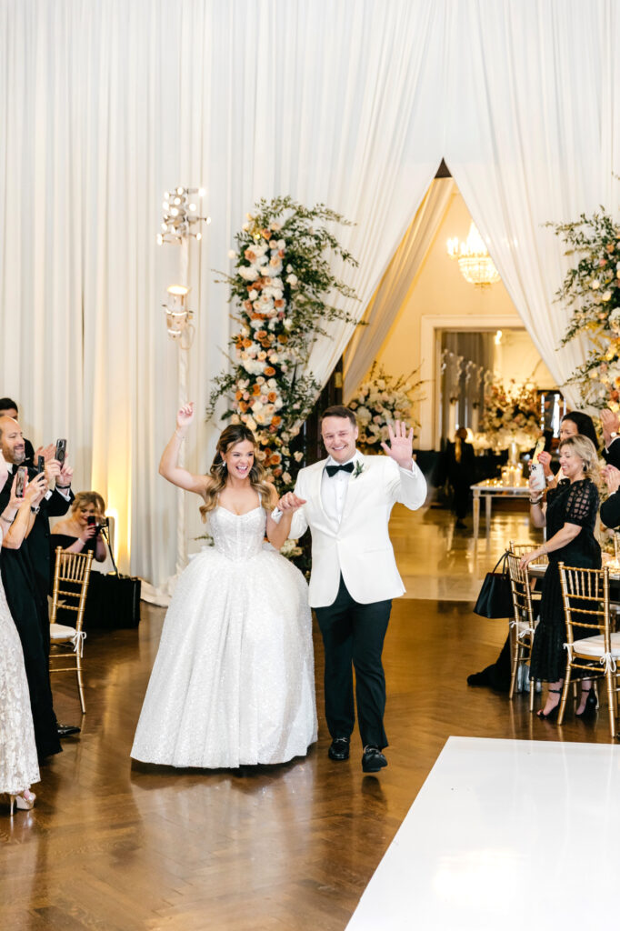 bride & groom entering their extravagant Union League of Philadelphia wedding reception