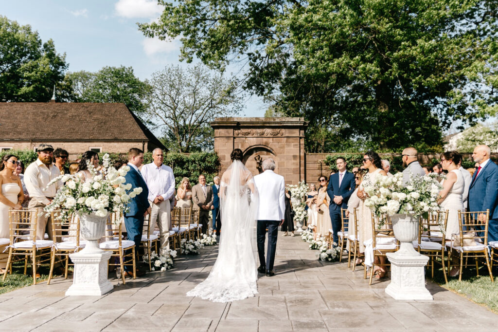 Pennsylvania bride walking down the aisle at her outdoor wedding ceremony at Tyler Gardens