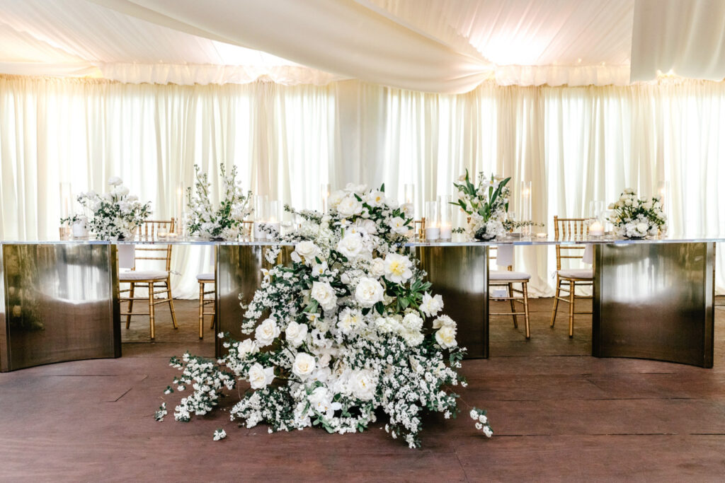 stunning sweetheart table decked out white lush white florals at Tyler Gardens spring wedding reception