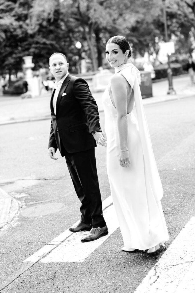 Philadelphia couple walking through the city during their summer engagement photoshoot by Emily Wren Photography