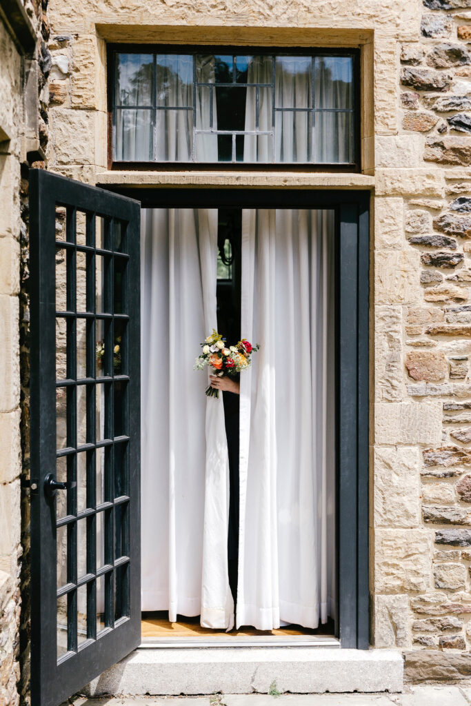 bride stepping out for her first look at Parque Ridley Creek by Emily Wren Photography