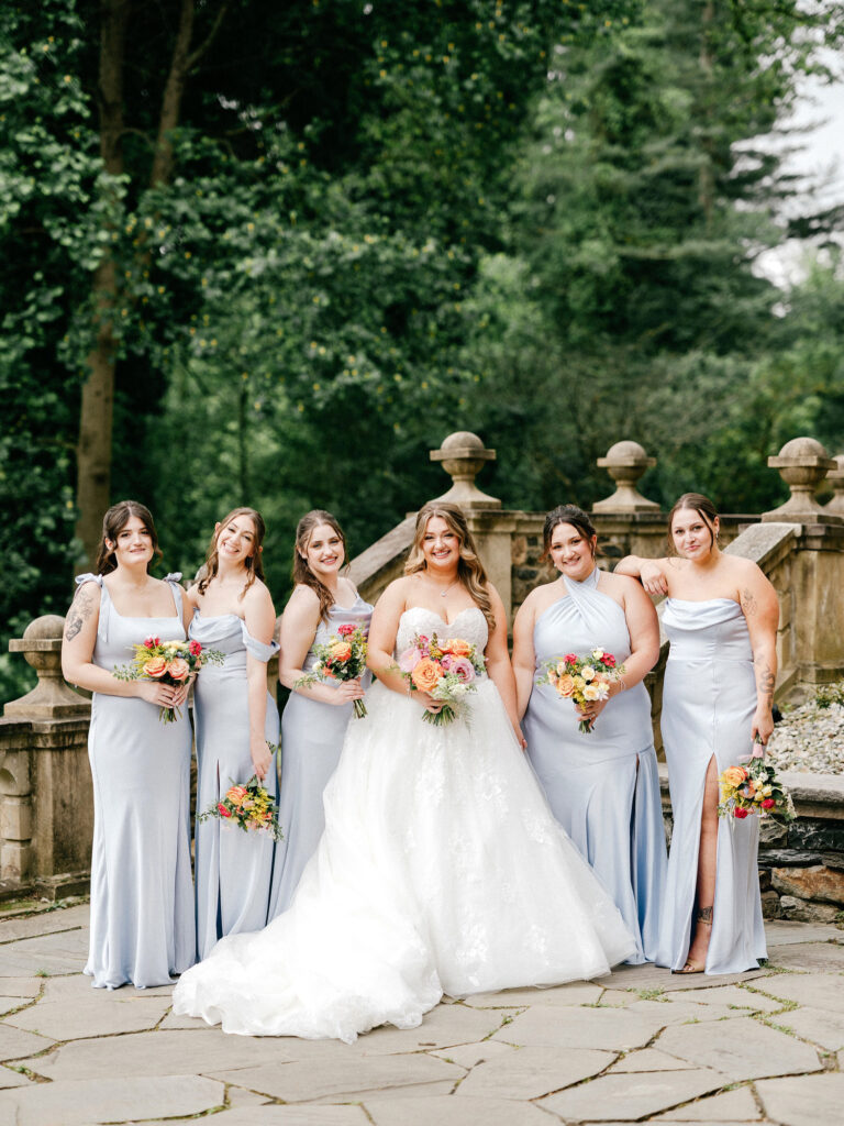 Pennsylvania bride with her bridesmaids in grey-blue bridesmaid dresses for a spring wedding day