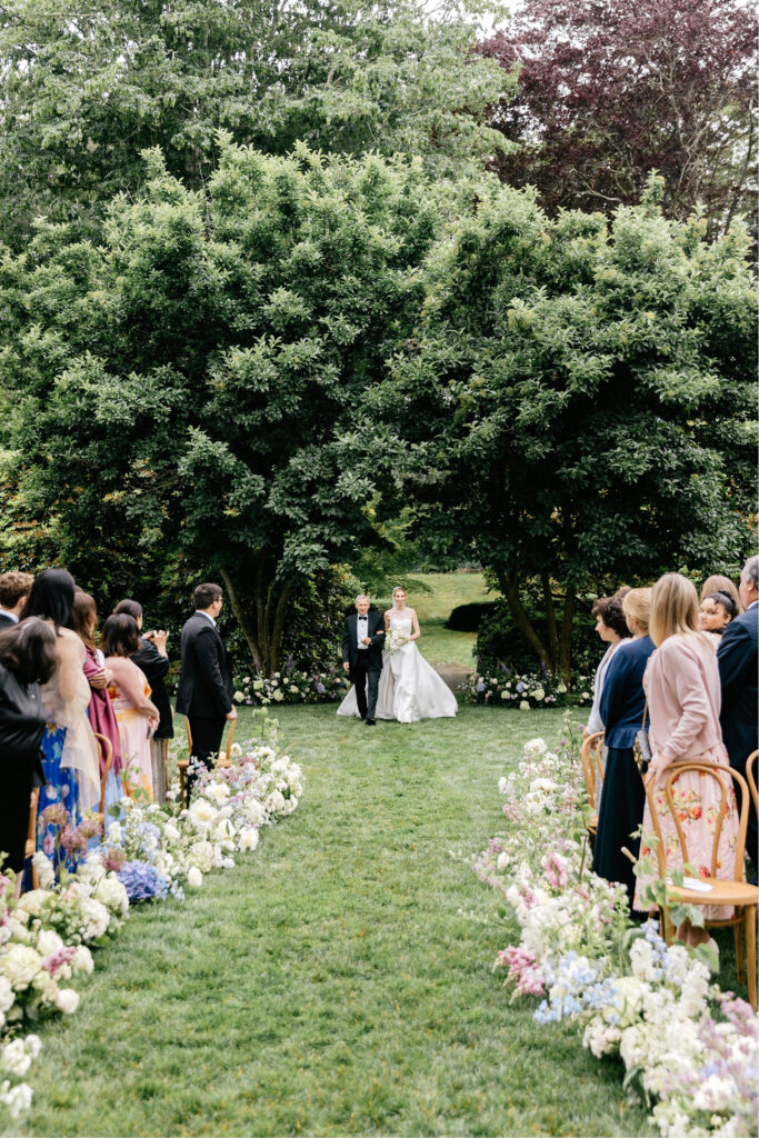 bride walking down the aisle at her outdoor Rhode Island wedding ceremony