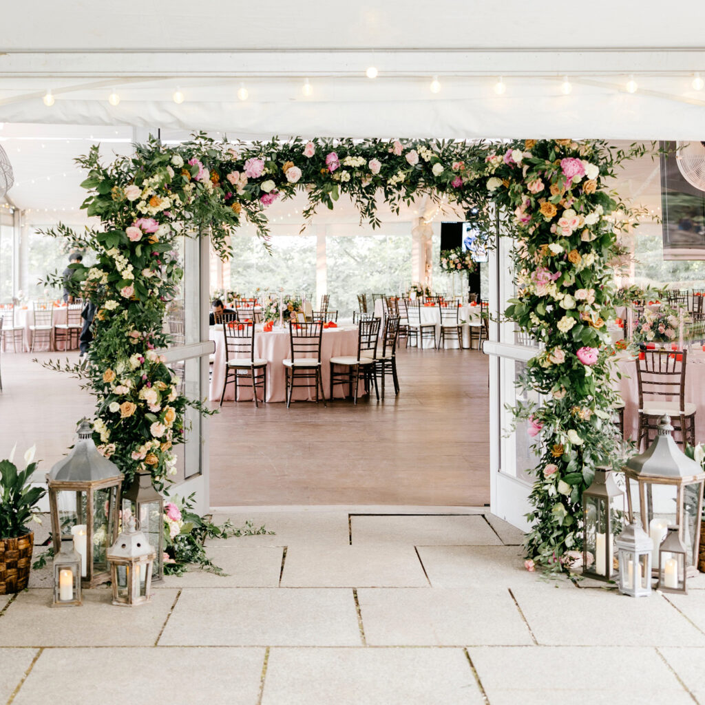 floral arch leading to reception hall at Bartram's Gardens by Philadelphia wedding photographer Emily Wren Photography