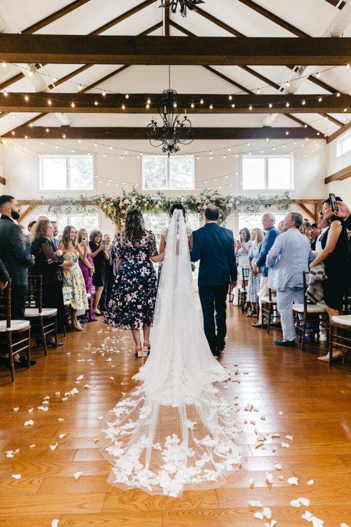 Philadelphia bride walking down the aisle at summer wedding ceremony at The Inn at Barley Sheaf