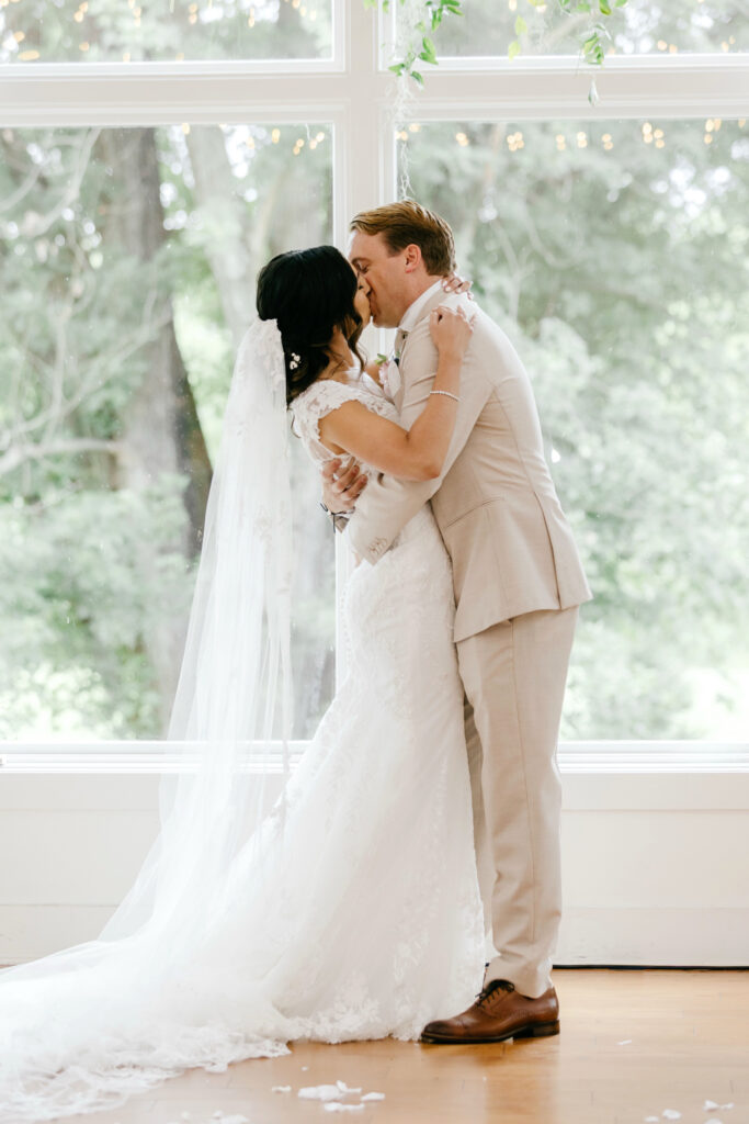 bride & groom's first kiss during their summer wedding ceremony at The Inn at Barley Sheaf