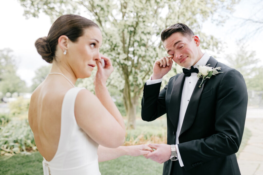 emotional private first look between bride and groom on their spring wedding day