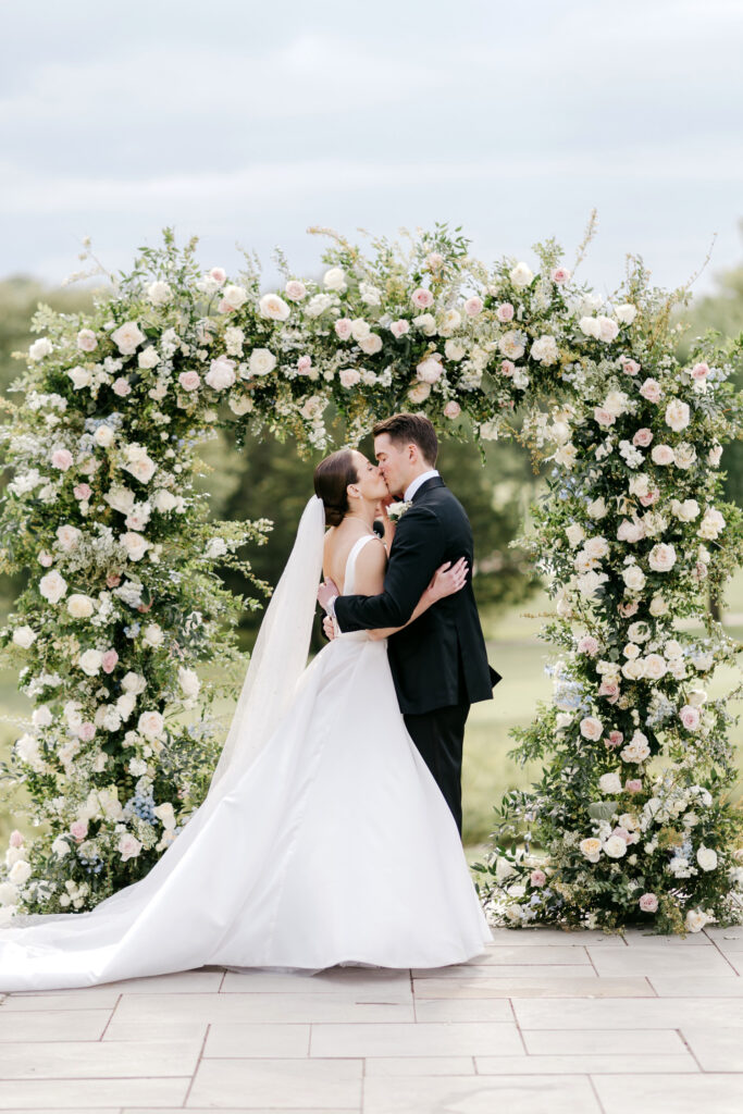 bride & groom's first kiss at their outdoor spring wedding ceremony in New Jersey