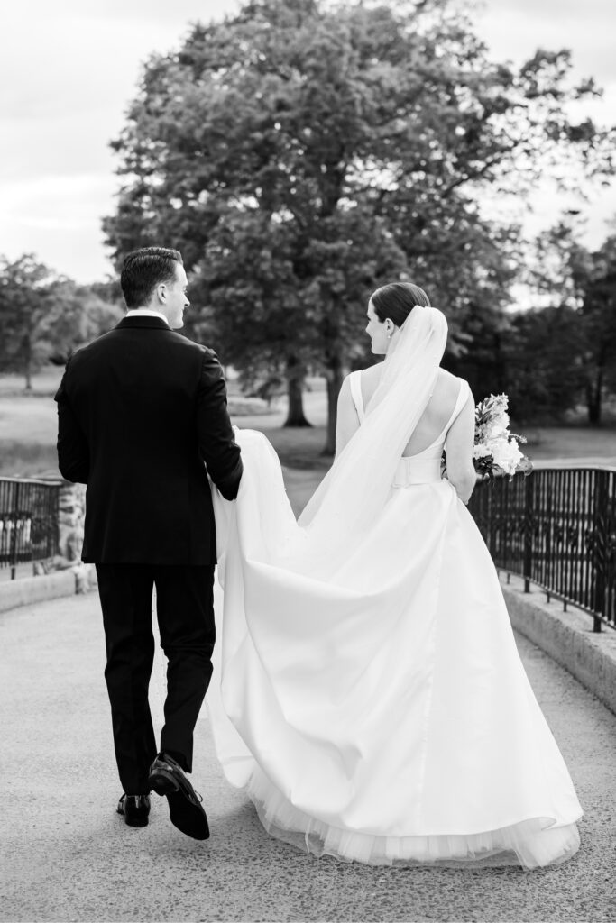 bride and groom walking around a New Jersey garden's grounds by Emily Wren Photography