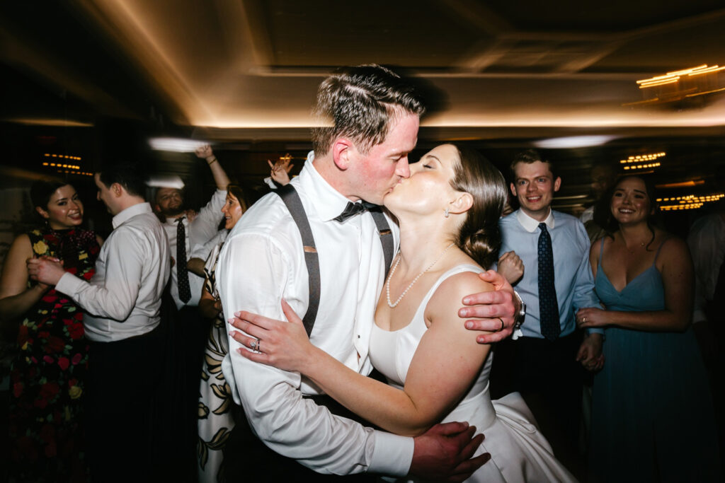 bride and groom kissing during their spring wedding reception at Fiddler's Elbow in New Jersey by luxurious wedding photographer Emily Wren Photography