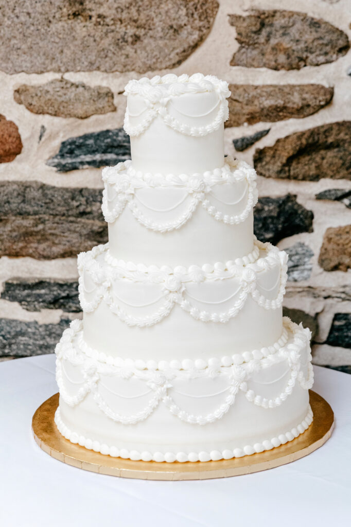 simplistic and vintage inspired all white four tier wedding cake by Emily Wren Photography