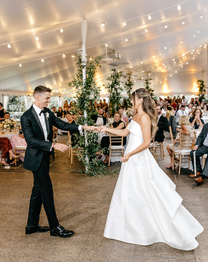bride and groom's first dance at their white-tented wedding reception at Appleford Estate