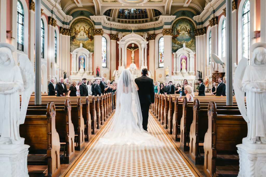 Philadelphia bride walking down the aisle at her summer wedding ceremony at St. Peter's Church