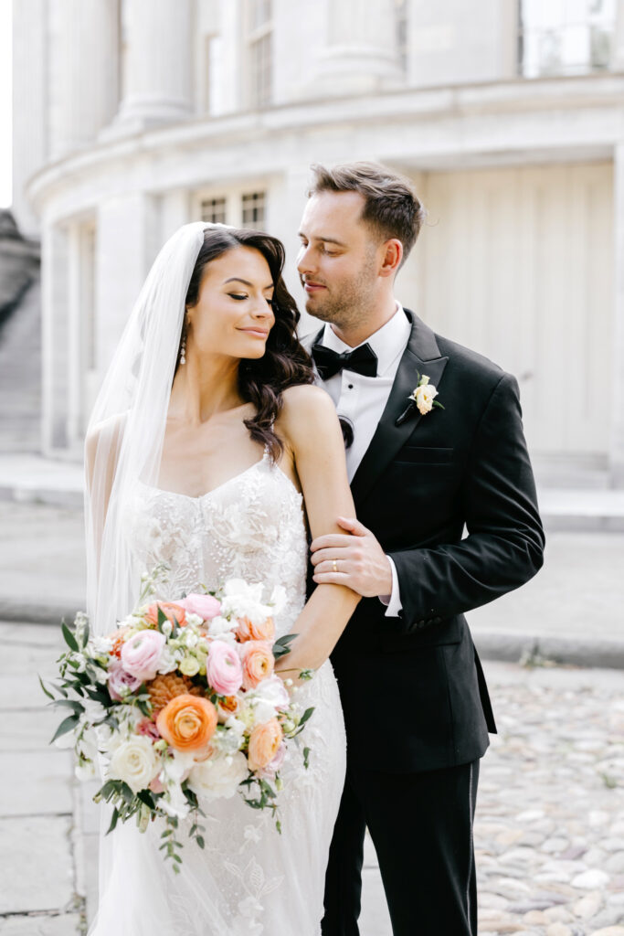 portrait of Philadelphia bride and groom at Merchant's Exchange on the summer wedding day
