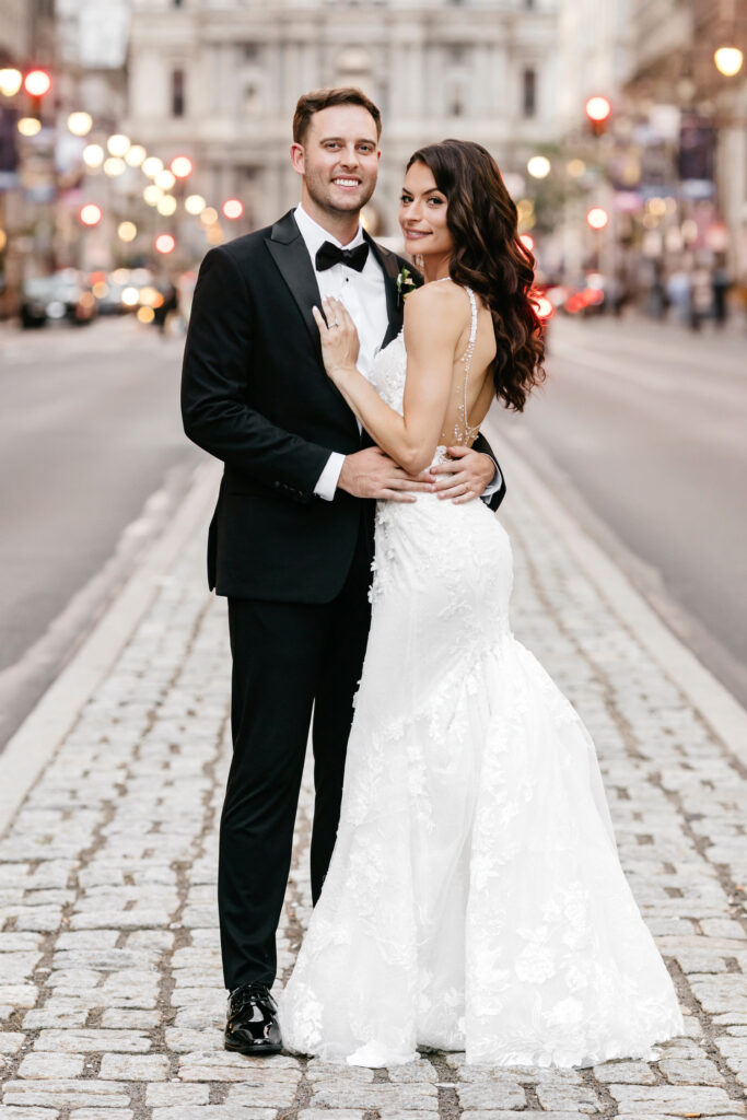 bride and groom portrait on Broad street in Center City Philadelphia on their summer wedding day