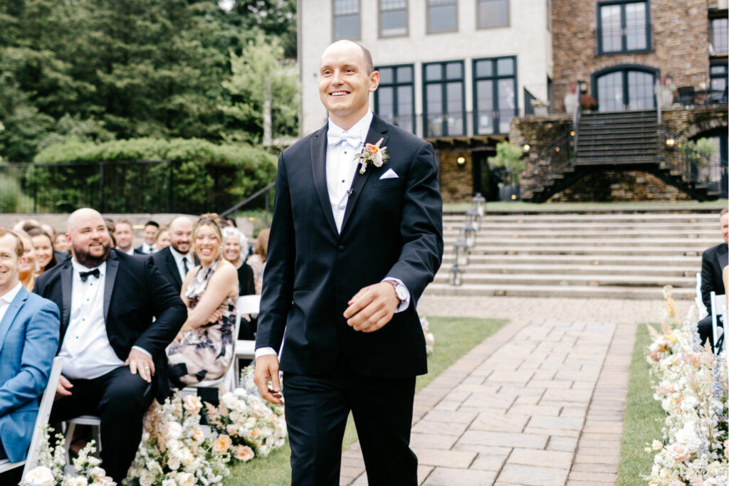 Philadelphia groom walking down the aisle at his summer wedding ceremony at The Lake House Inn