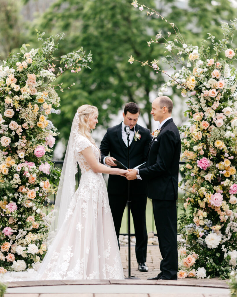 bride and groom standing at the aisle at their outdoor lakeside summer wedding ceremony at The Lake House Inn