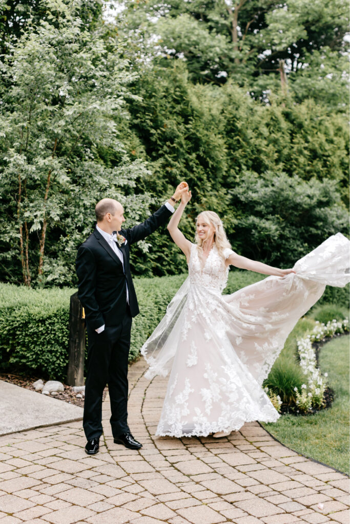 bride and groom portrait session in the gardens of The Lake House inn on their summer wedding day in Philadelphia
