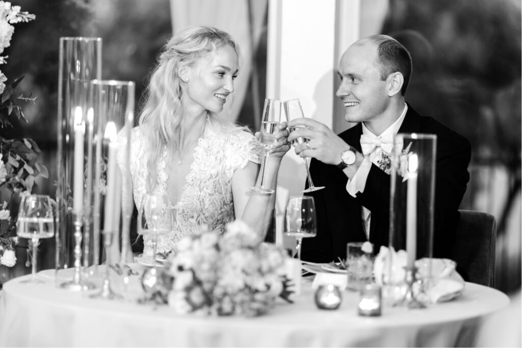 bride and groom toasting during speeches at their summer wedding reception at The Lake House Inn