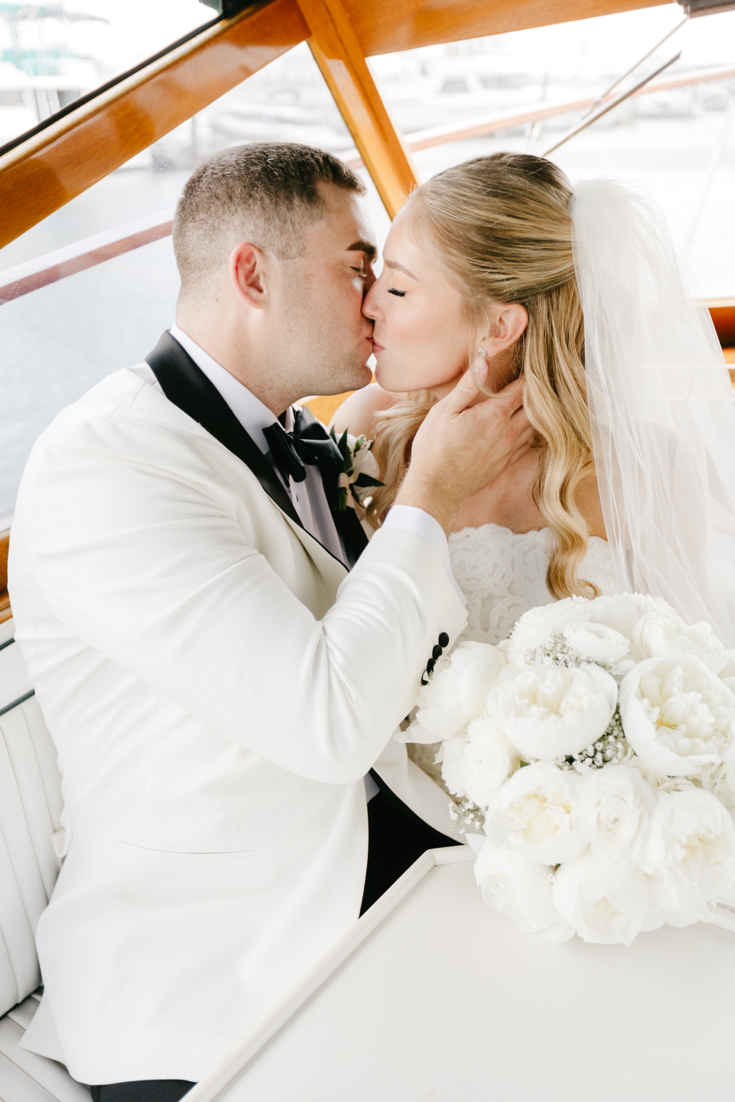 bride and groom kissing on the Phantom Boat from Sea Philly on their spring wedding day