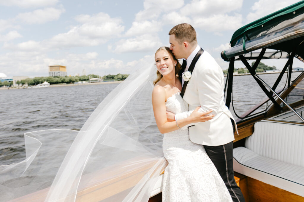 romantic portraits of a Philadelphia bride and groom on their spring wedding day riding a boat along the river by Emily Wren Photography
