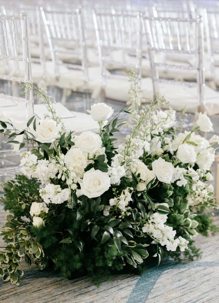 all white floral bouquets aligning the ceremony aisle at a Philadelphia wedding at the Hilton Hotel at Penn's Landing