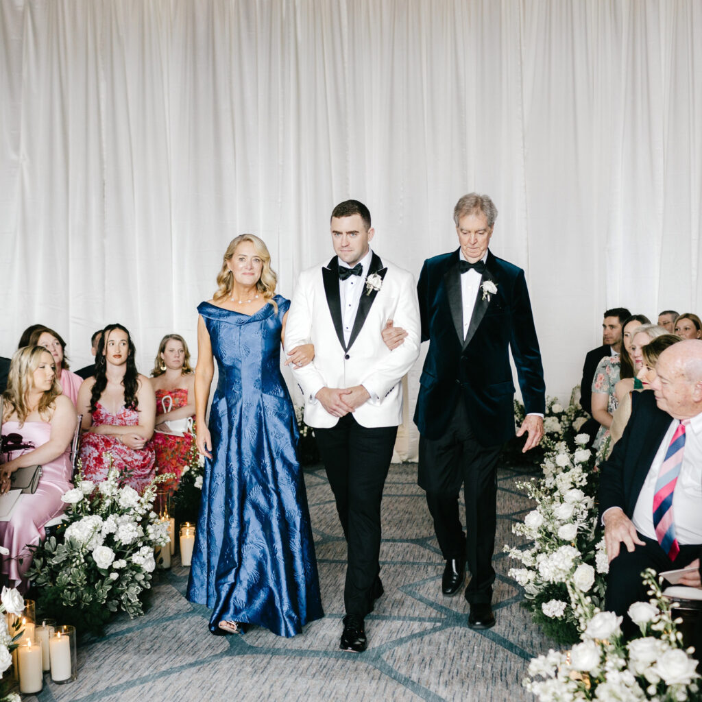 Philadelphia groom walking down the aisle at his late spring wedding ceremony at the Hilton Hotel at Penn's Landing