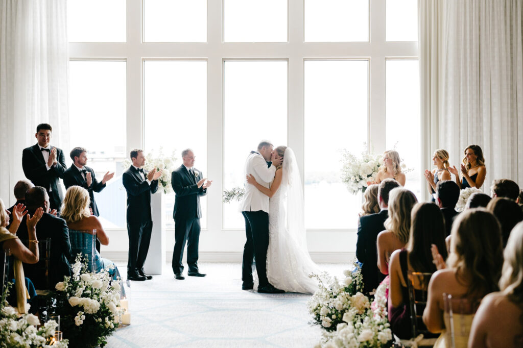 bride & groom's first kiss at their late spring wedding ceremony at the Hilton Hotel in Philadelphia by Emily Wren Photography