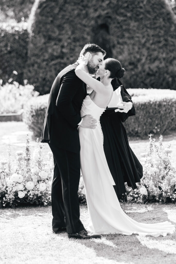 New Jersey bride and groom's first kiss at their outdoor summer wedding ceremony at Beach Plum Farm