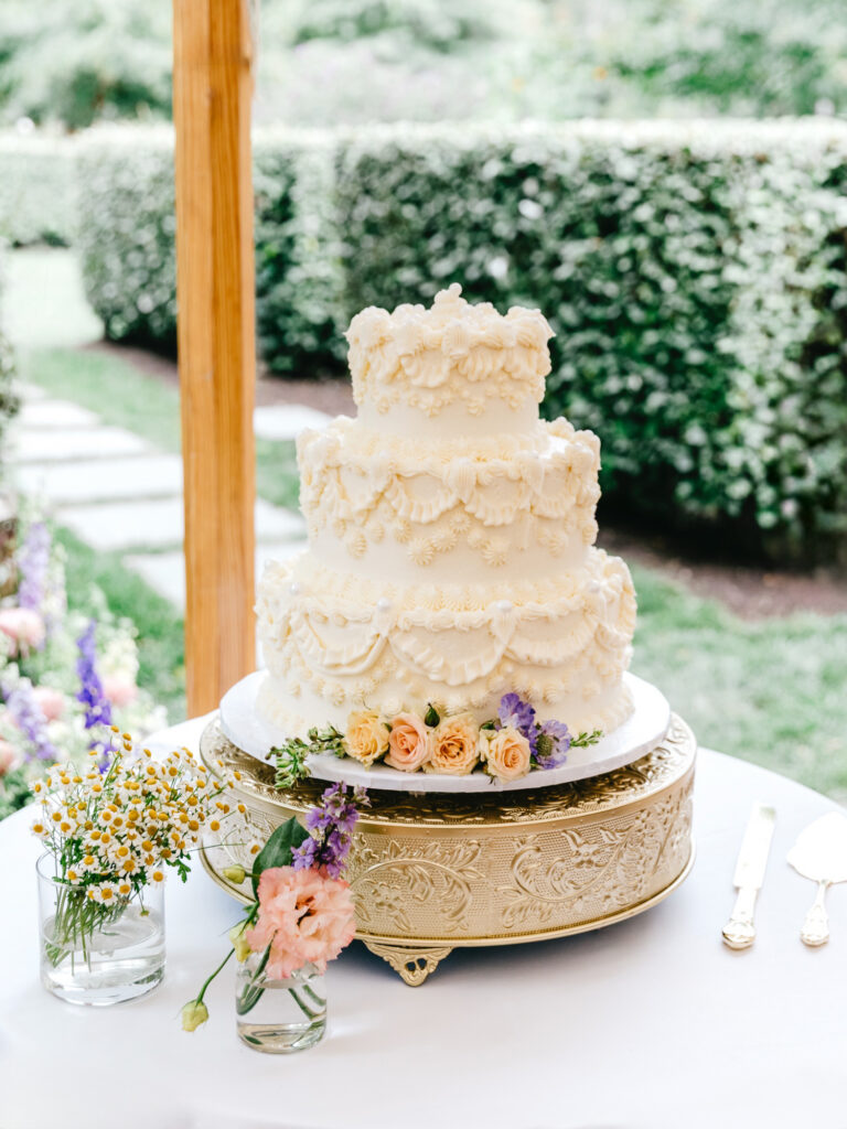 three tier vintage-inspired wedding cake for outdoor summer garden wedding reception