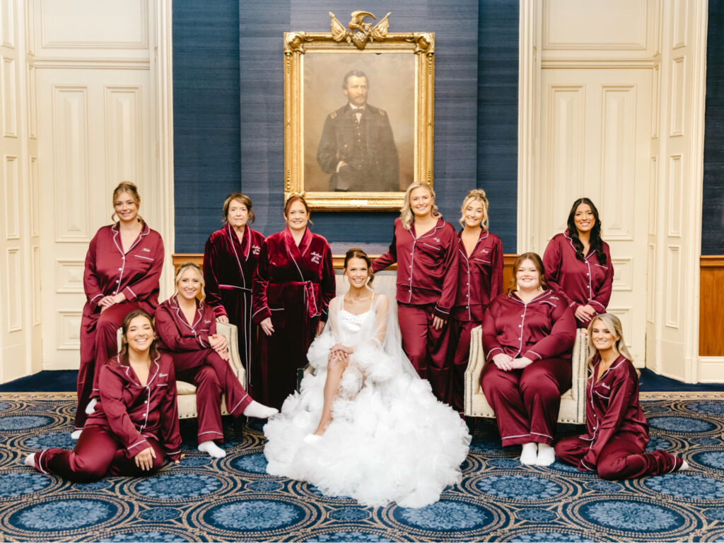 Philadelphia bride with her bridesmaids on the morning of her winter wedding day in matching red pajama sets at The Union League