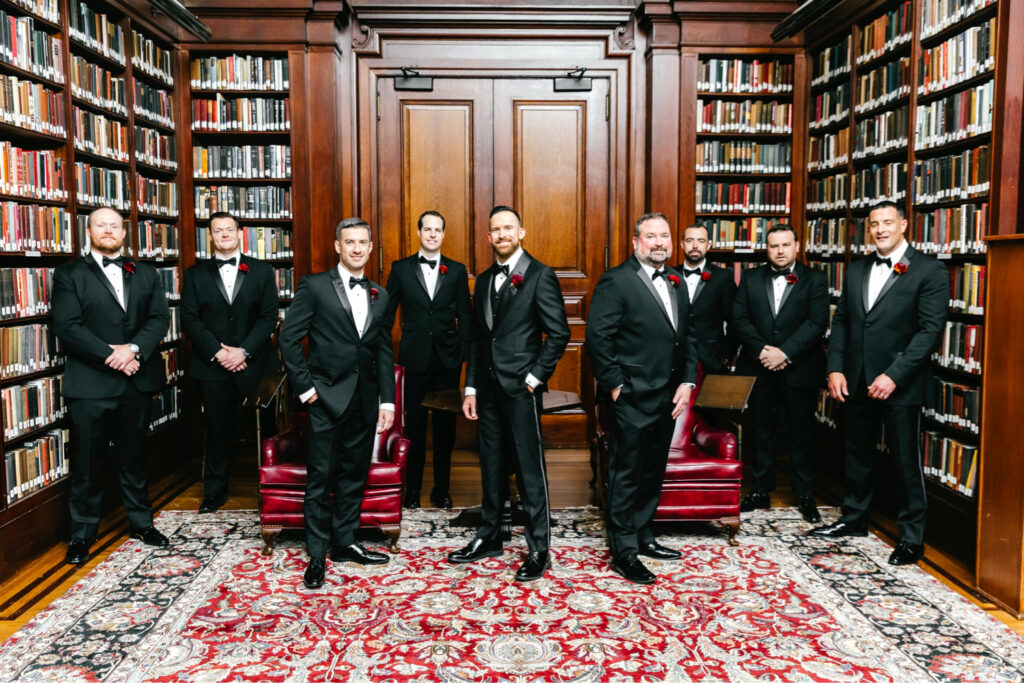 Philadelphia groom with his groomsmen in the library of The Union League by Emily Wren Photography