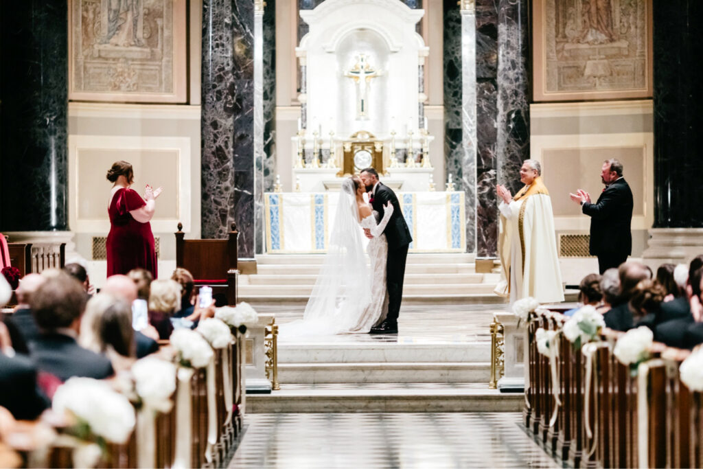 bride and groom's first kiss at their winter wedding ceremony in Center City Philadelphia