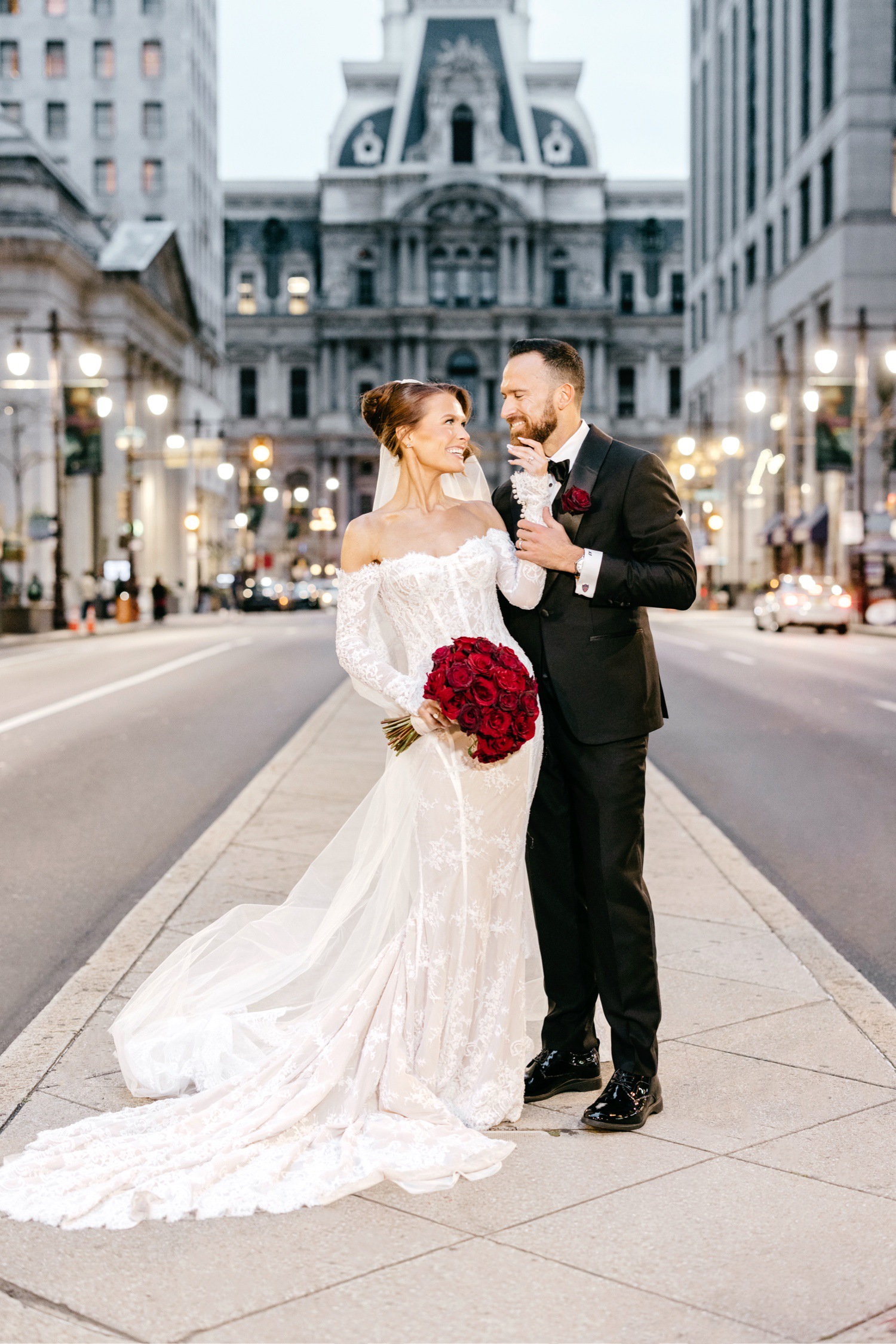 romantic wedding portrait of Bride and groom in front of City Hall in Center City Philly on Broad Street